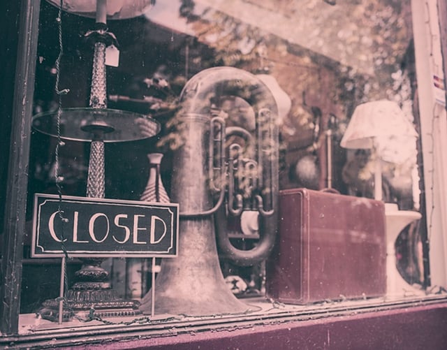 An image of a retail store window with a closed sign
