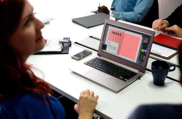 Woman sitting at a laptop computer that says ideas