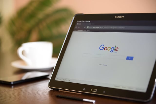 Image of a laptop displaying a Google search page