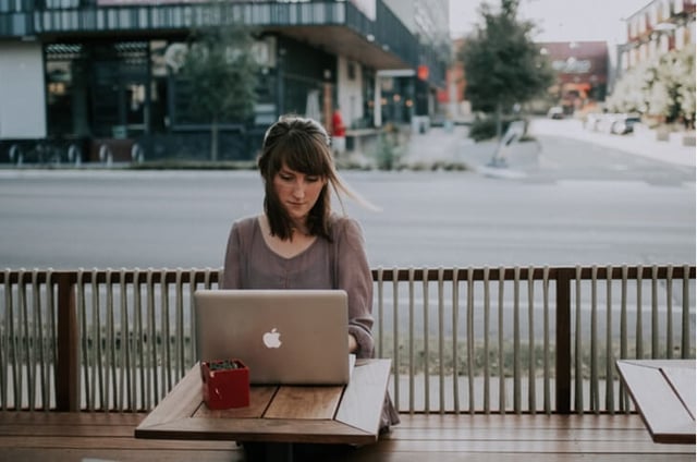 Woman using a laptop outside