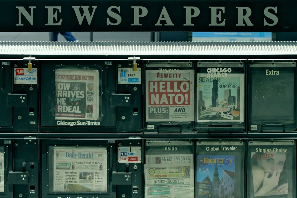 Image of a newspaper stand with a variety of newspapers for sale