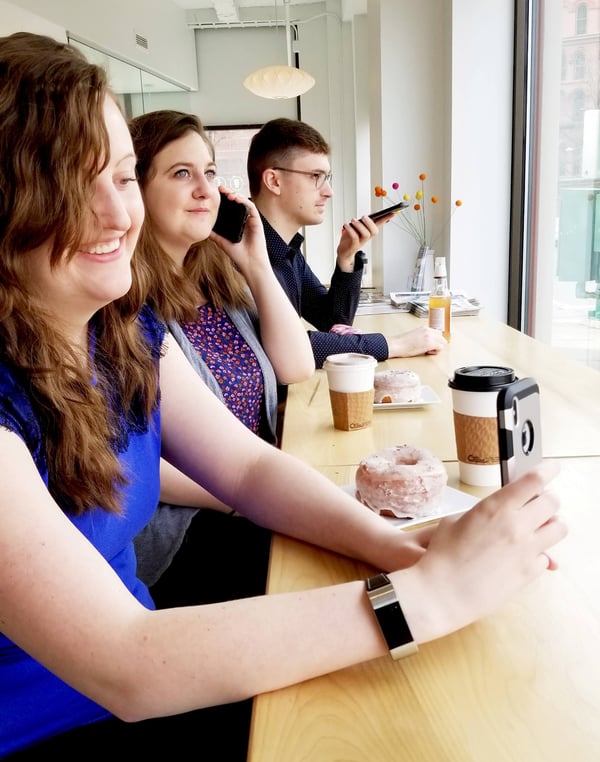 Young people in cafe using cell phones