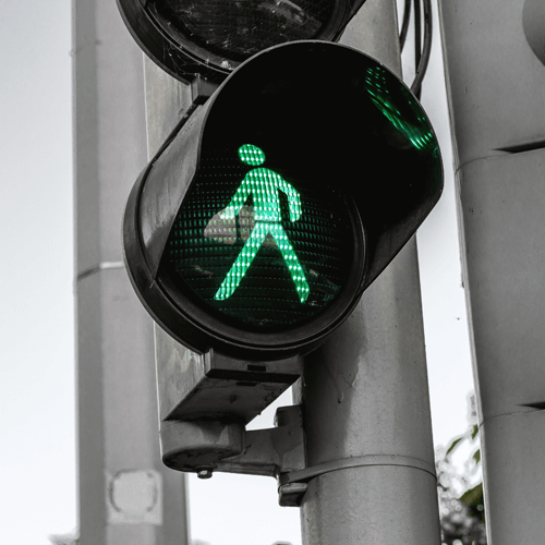 Illuminated green man on traffic light