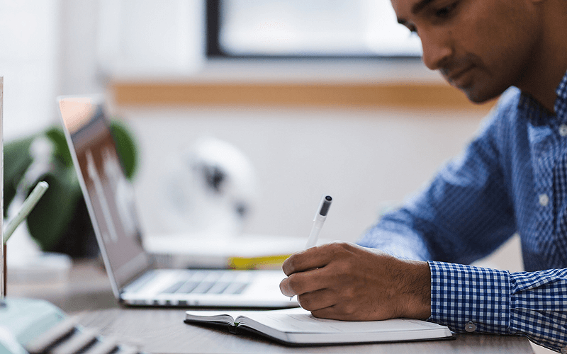 Man researches cars on his laptop