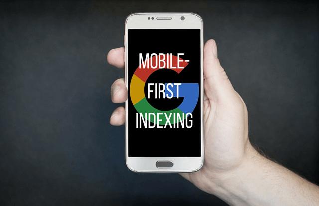 Photo of a hand holding a cell phone with a Google logo and the words mobile-first indexing